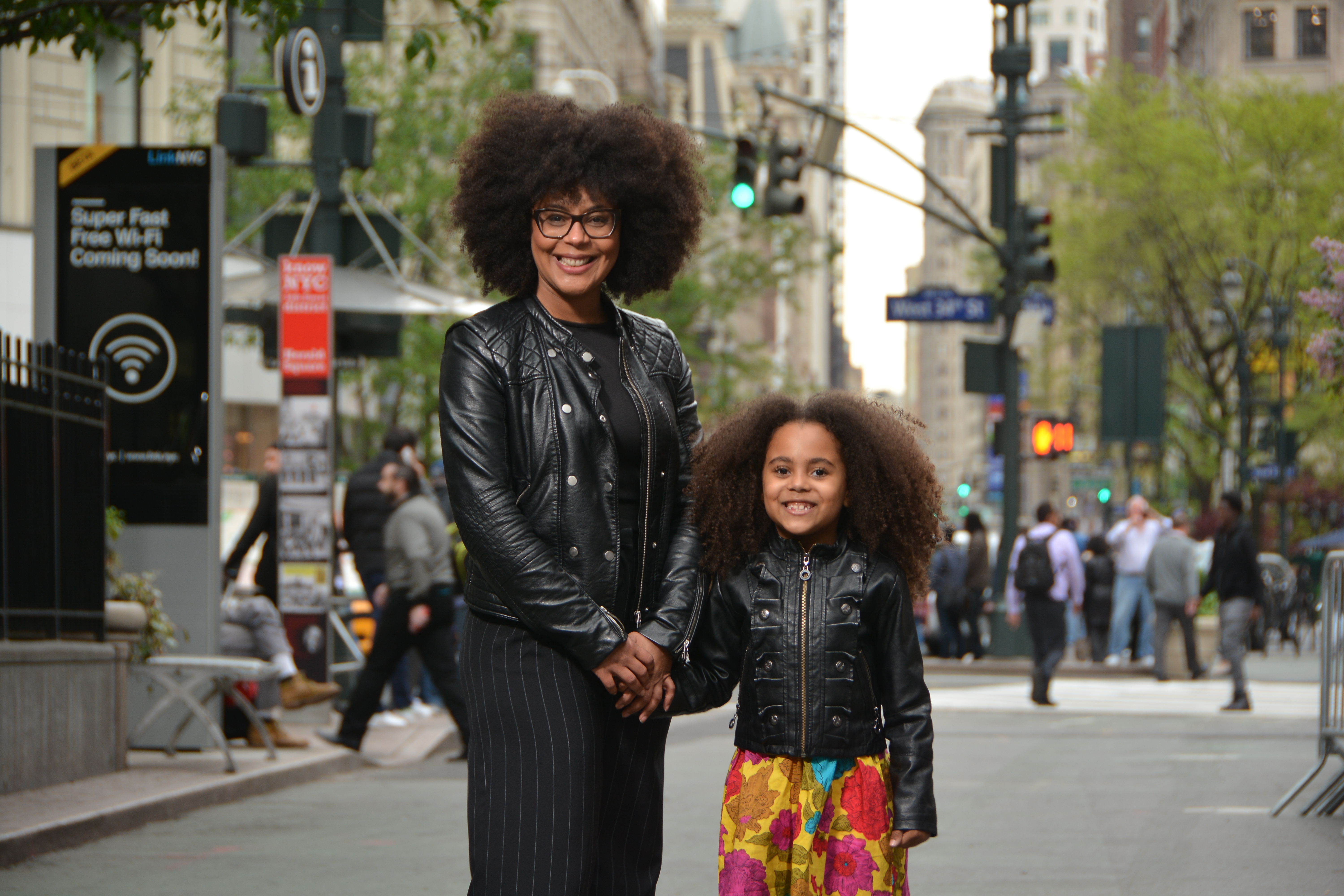 Woman in NYC holding hands with her daughter