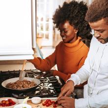 young_african_american_couple_cooking_dinner_in_kitchen