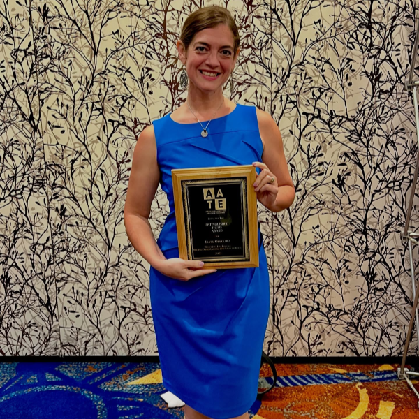 CUNY SPS MAAT alum Elyse Orecchio proudly displays her AATE thesis award